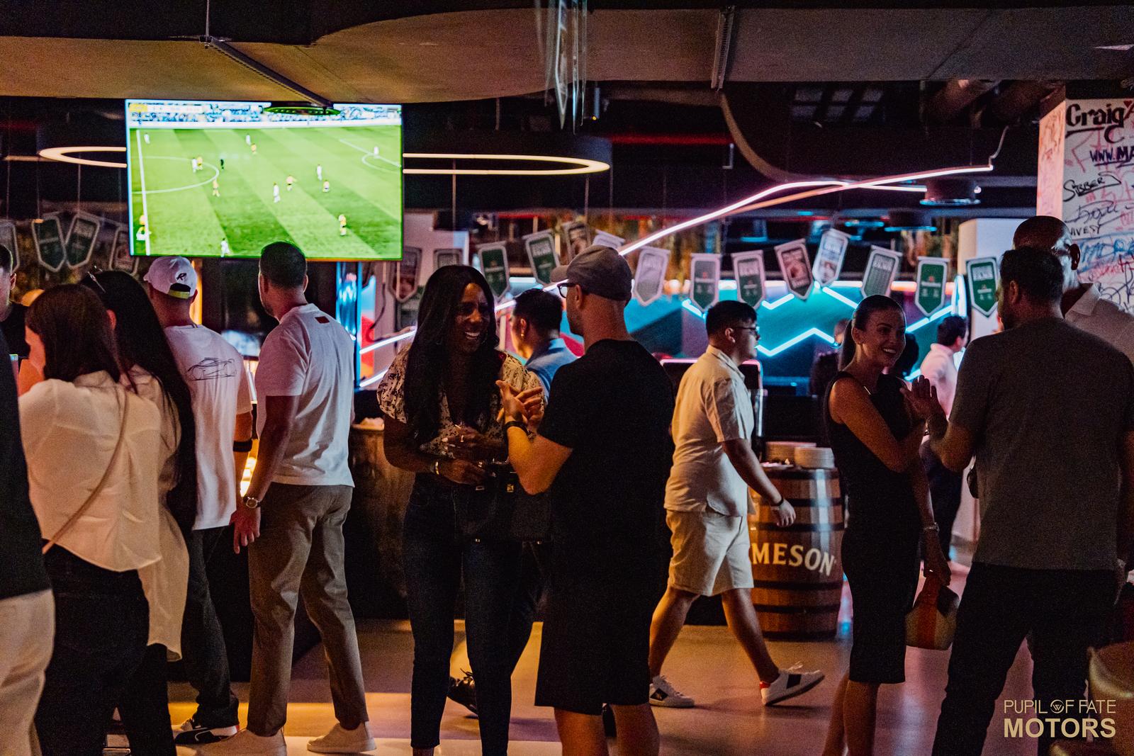 Corporate group socialising at Five Iron Golf UAE sports bar Dubai